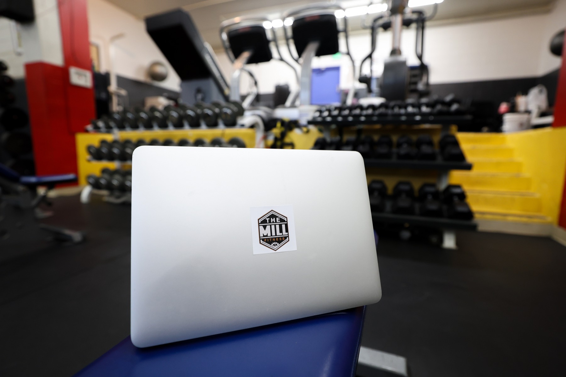 Laptop in a gym representing online programming